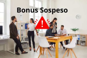 ragazzi che lavorano e la scritta bonus sospeso e un segnale attenzione